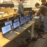 Seniors and members of the 1:1 Student Help Desk Andrew Lobos, Nick Joniec, Collin Enders and Aaron Jandzio (left to right) set up a new batch of 1:1 computers.